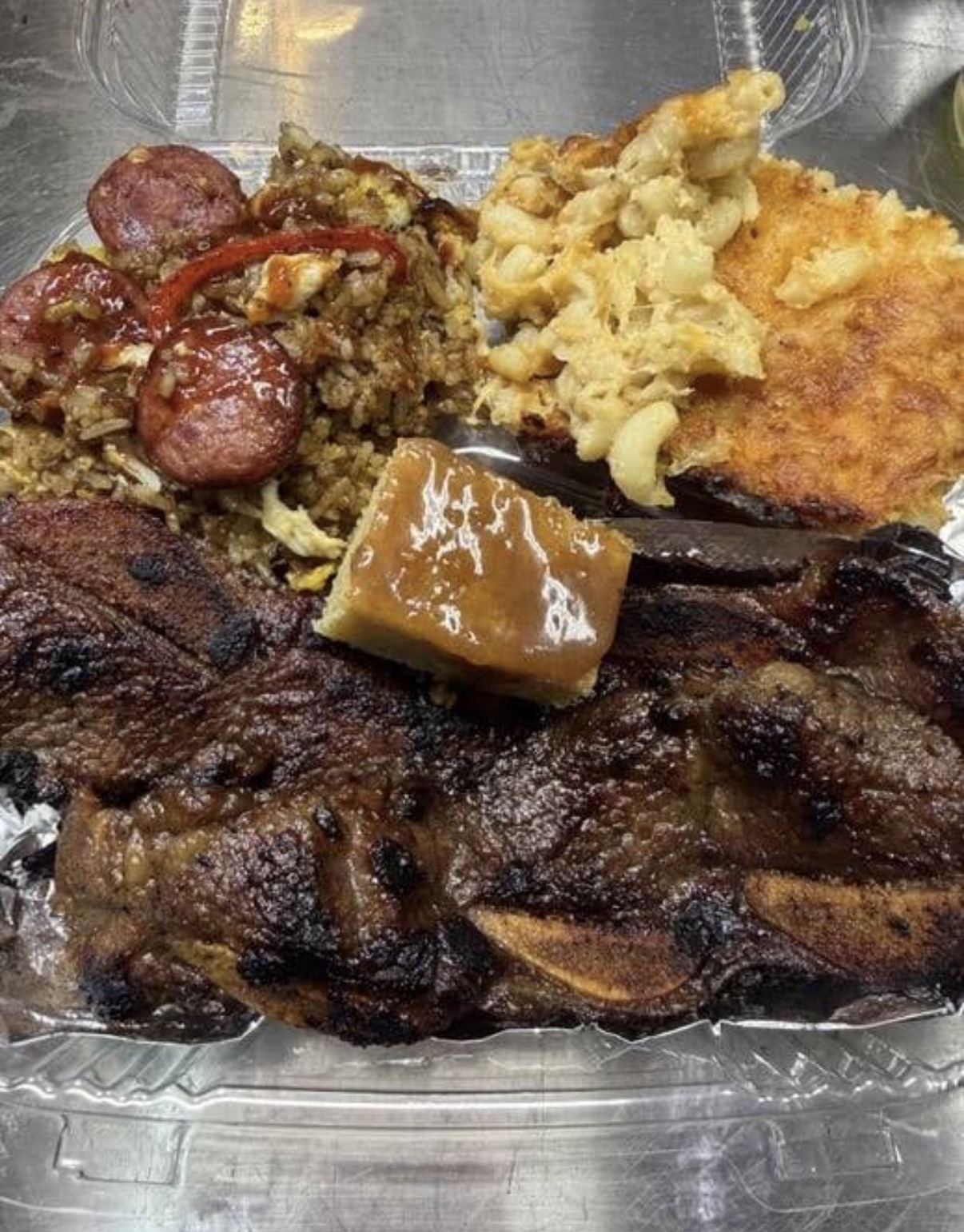 Flame-seared lamb chops with jambalaya fried rice, baked mac and cheese and cornbread