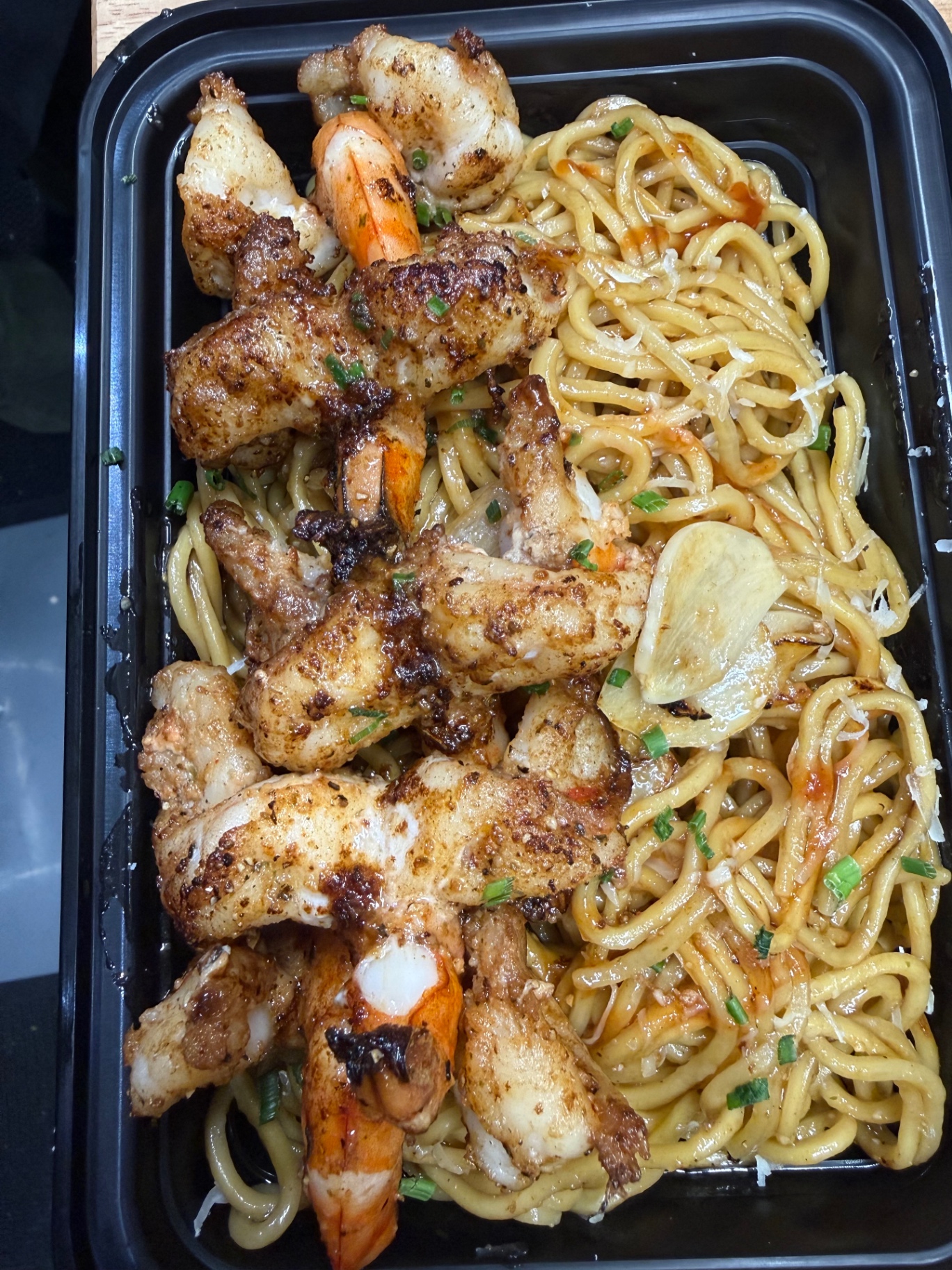 Garlic butter shrimp over noodles